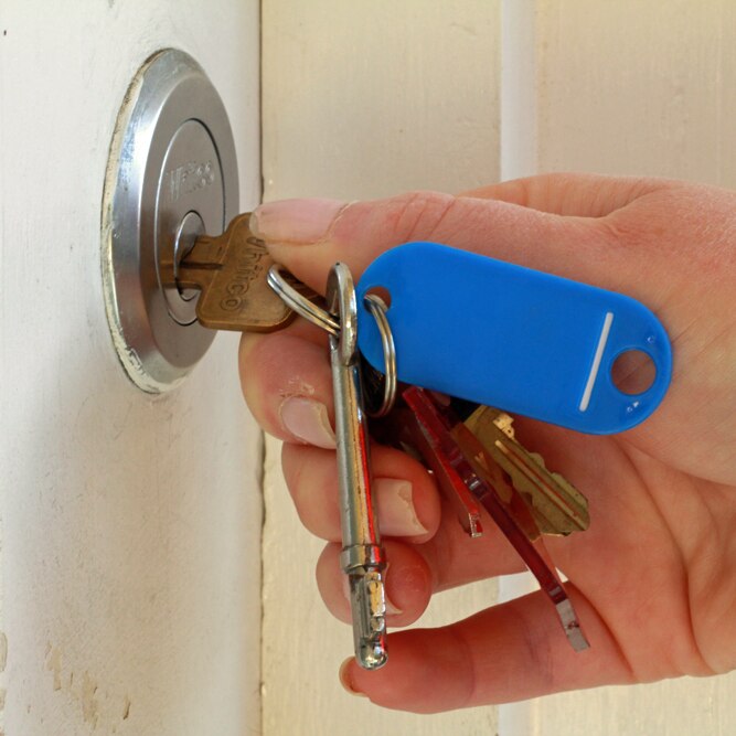 Woman opens a door with a key