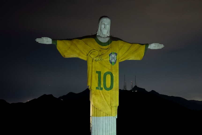 Christ the Redeemer statue illuminated with an image of Pele's Brazillian jersey.