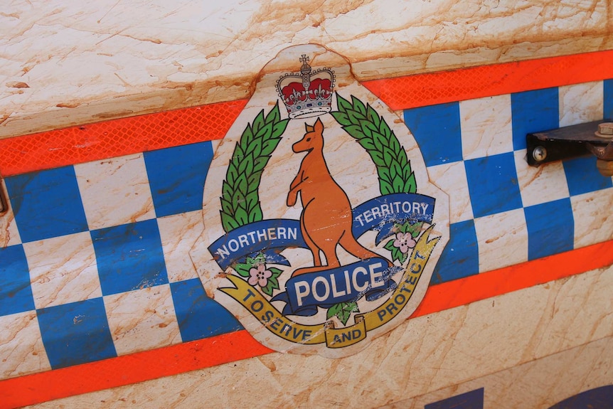 NT Police insignia on mud-splattered car door