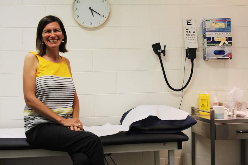 a doctor sitting in her clinic room