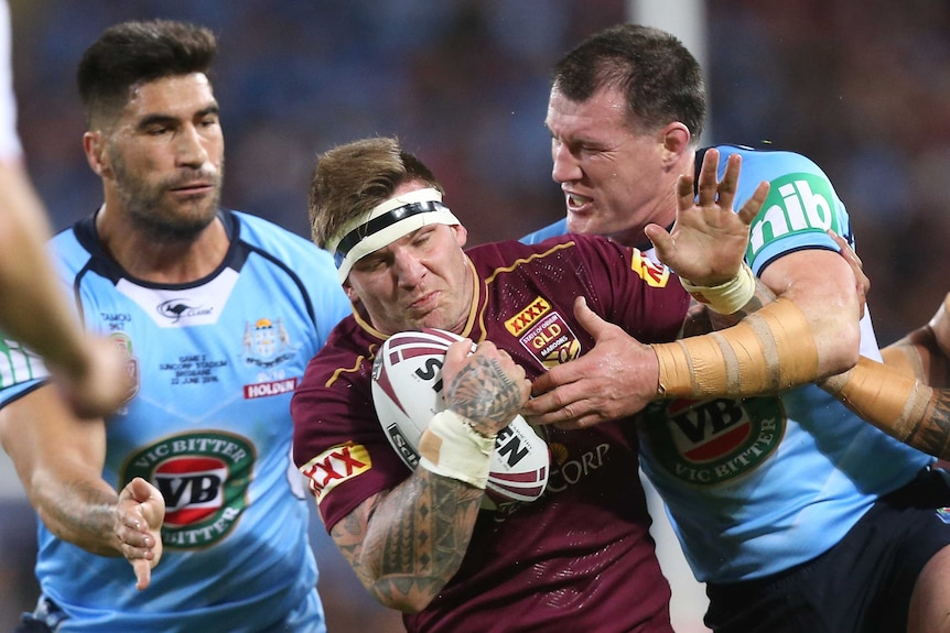 Josh McGuire is tackled by Paul Gallen