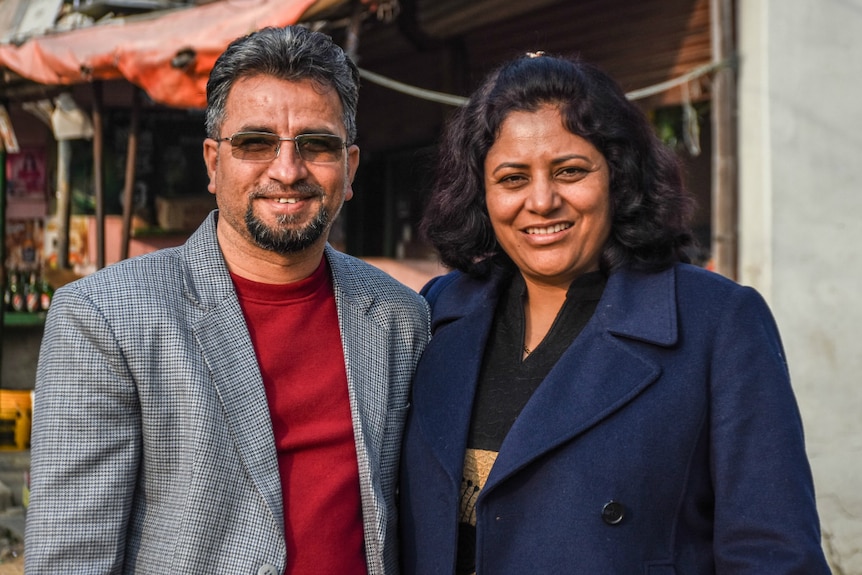 A man and a woman pose for the camera.