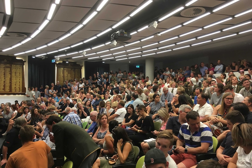 A meeting of  hundreds of people at Trinity Grammar School in Kew.