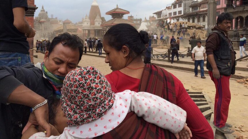 A family checks on their children in the Patan district