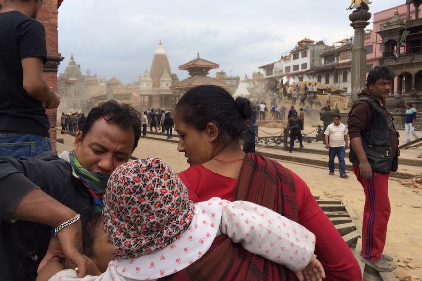 A family checks on their children in the Patan district