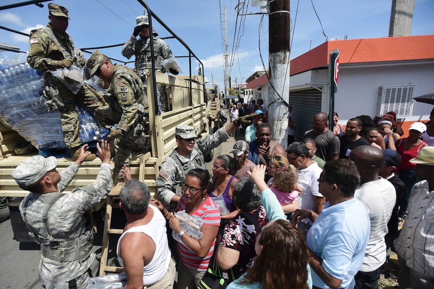 National Guardsmen pass out water to residents of Puerto Rico affected by Hurricane Maria.