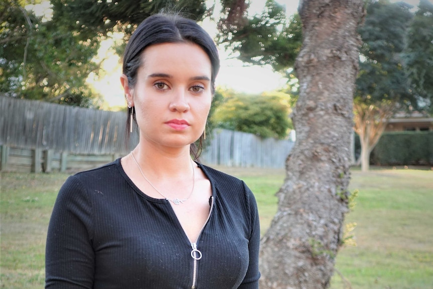 Portrait of Rachel Park standing in a dog park.