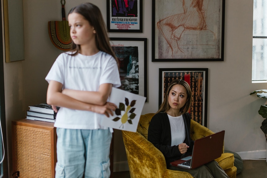 A mother and daughter looking upset with each other at home. 