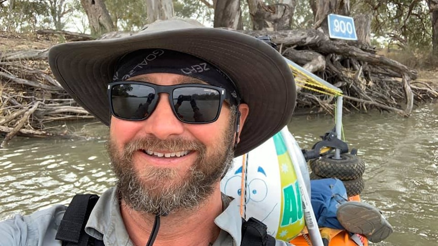 Marc Nieuwenhuys in a kayak on the River Murray with bank in background.