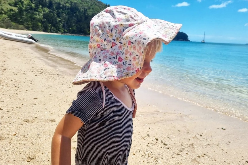 Picture of a one-year-old girl at the beach.