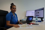 Telstra call centre team leader Thecla Brogan at her desk.
