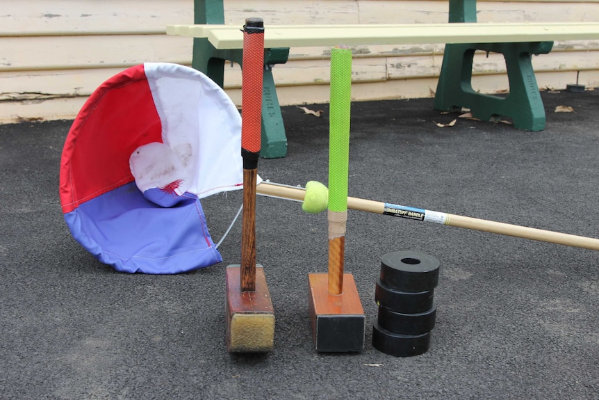 Mallets, ruber rings and a catcher used in the sport of Trugo.