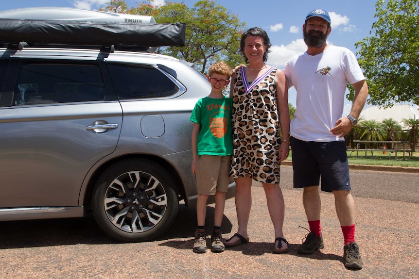 Siobhan Toohill standing with her family beside their car in front of the Windorah Pub in south-west Queensland.