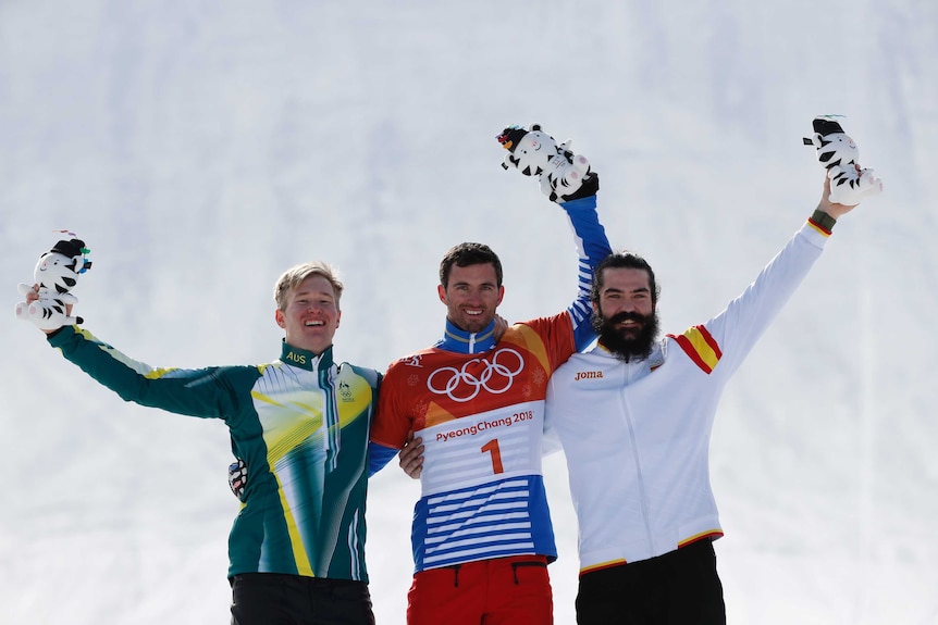 Jarryd Hughes (L) celebrates with gold medallist Pierre Vaultier (C) and bronze medal winner Regino Hernandez.