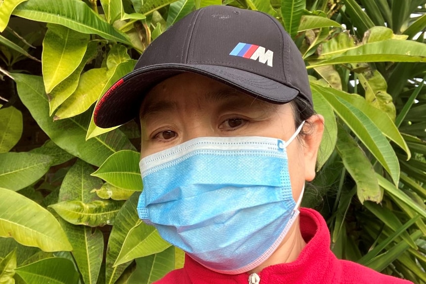 A close-up of Aunty Wu wearing a surgical face mask. 