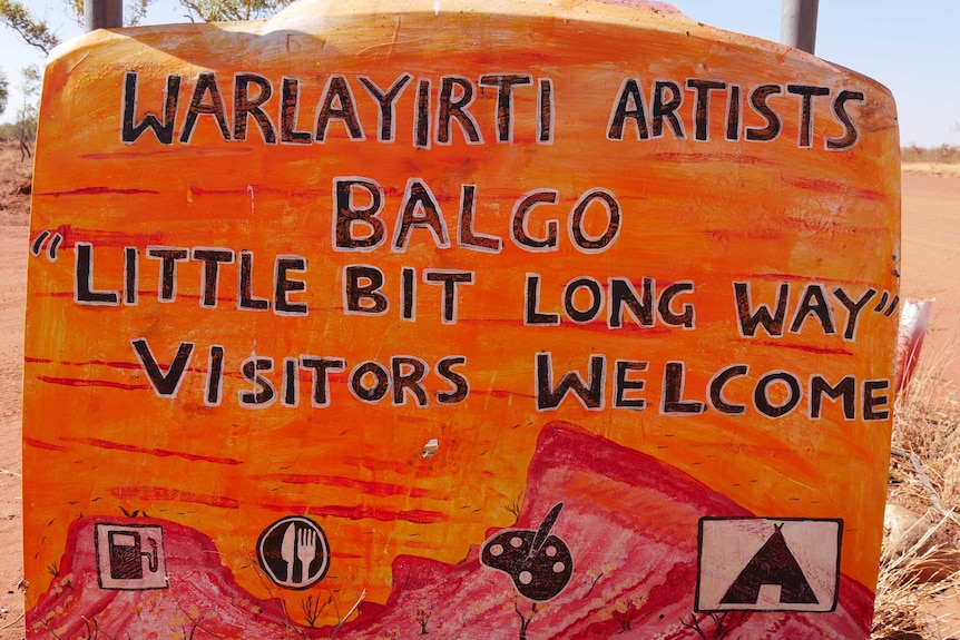 A sign at the entrance to the Balgo community painted on a car bonnet.