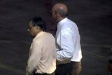 Former Bundaberg surgeon Jayant Patel being escorted onto a Qantas jet in LA