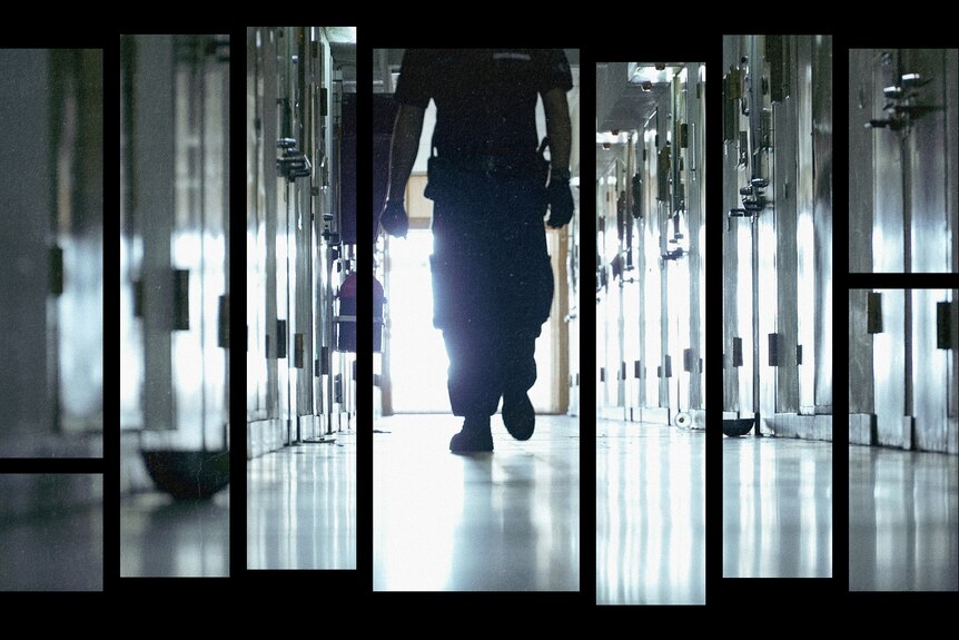 A hallway lined with jail cell doors. A silhouetted figure walks down the hall towards the camera.