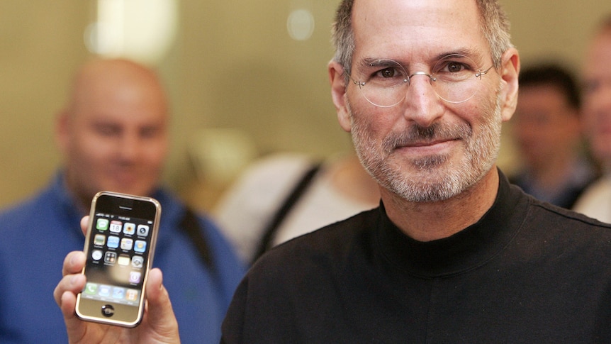 Steve Jobs poses with an iPhone during a press conference in Berlin 19 September 2007.