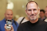 Steve Jobs poses with an iPhone during a press conference in Berlin 19 September 2007.