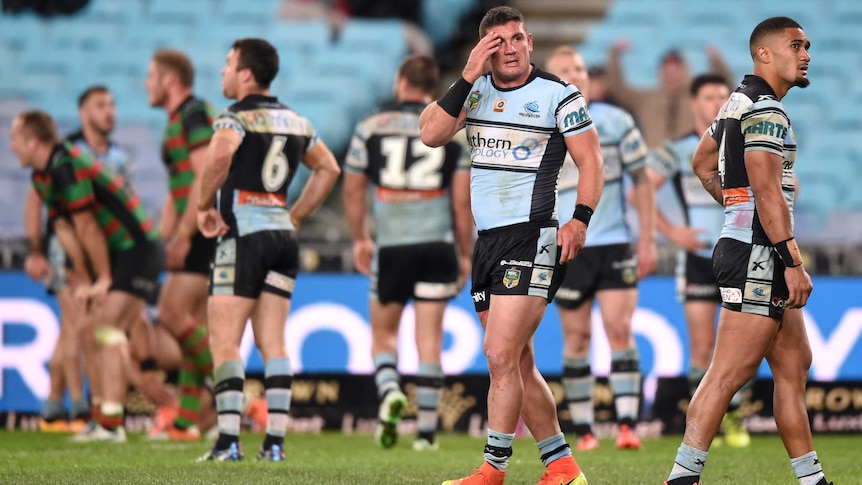 Cronulla's Chris Heighington (C) and Ricky Leutele (R) look on after a try scored by Souths.