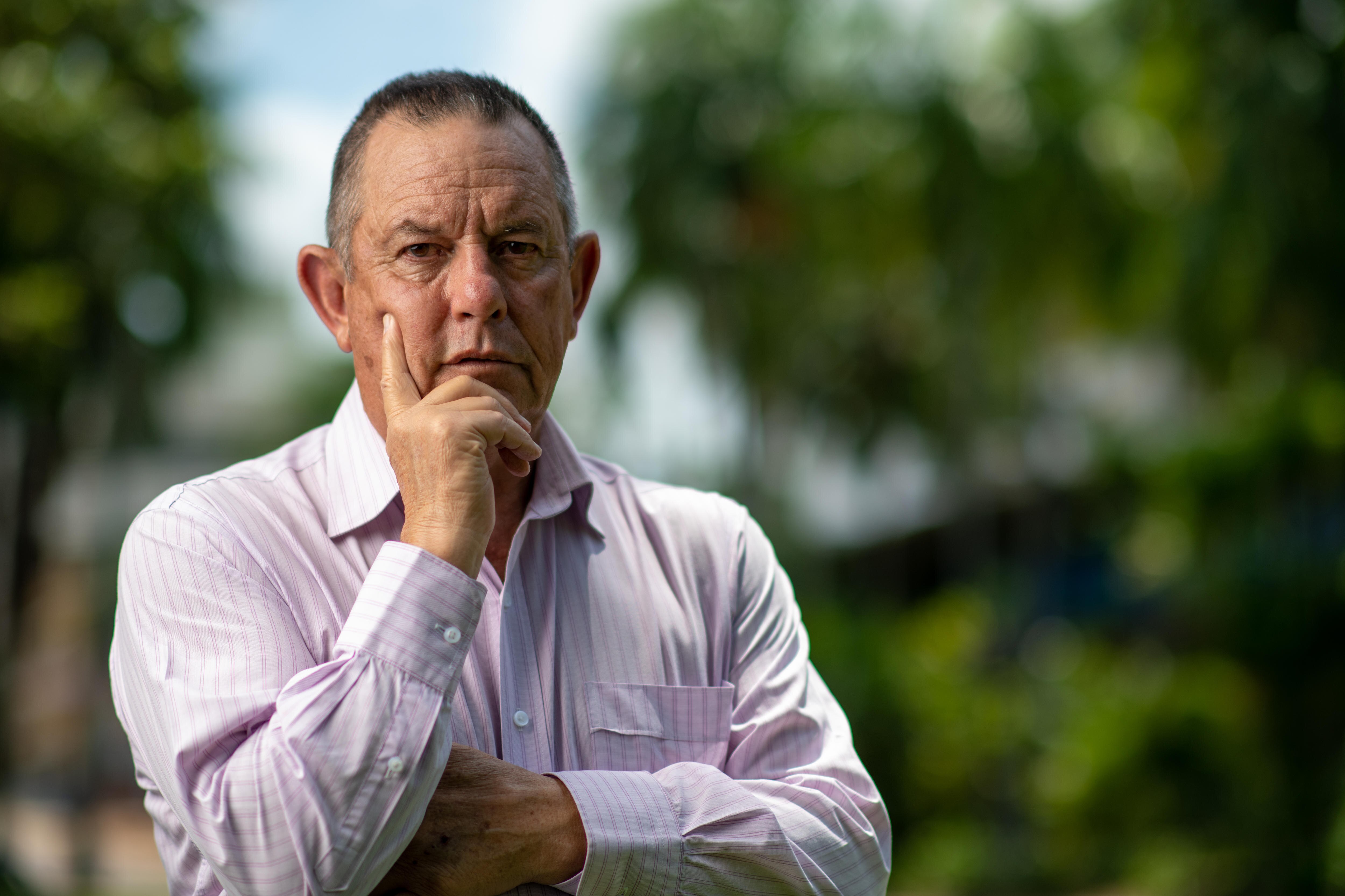 a middle-aged man with a serious expression 