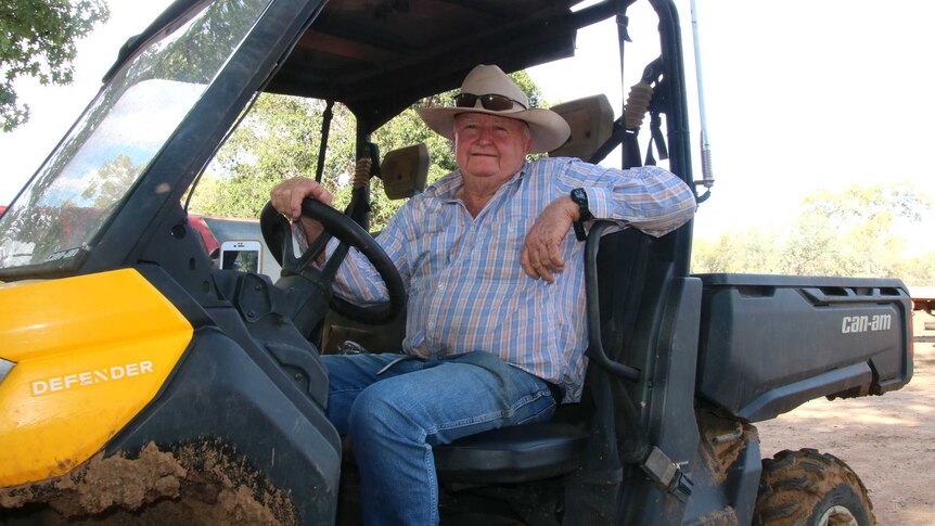 A man, Blue Bredhauer, is sitting in a muddy RTV, looking at the camera.