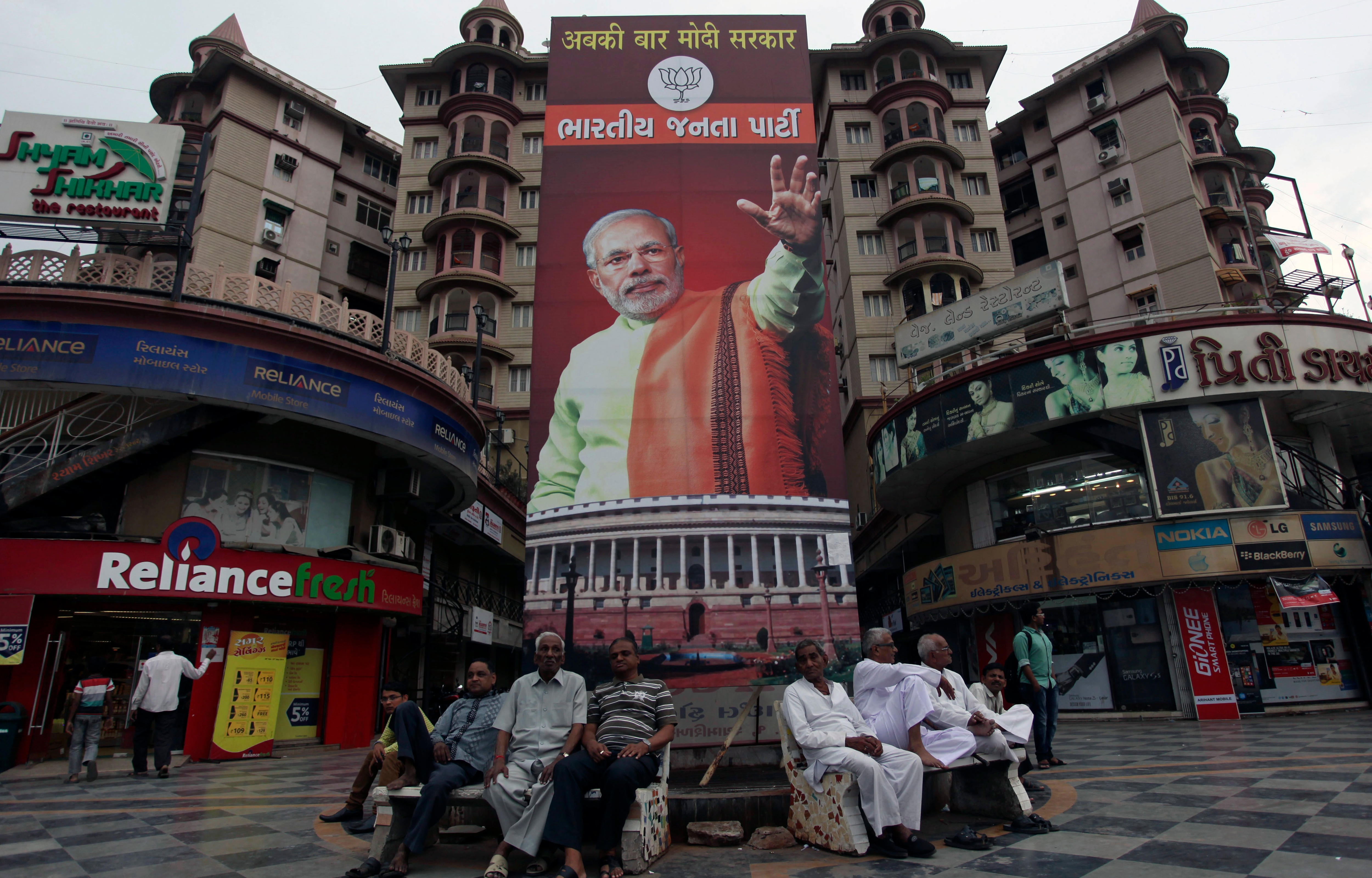 A large billboard showing a man with one arm raised.