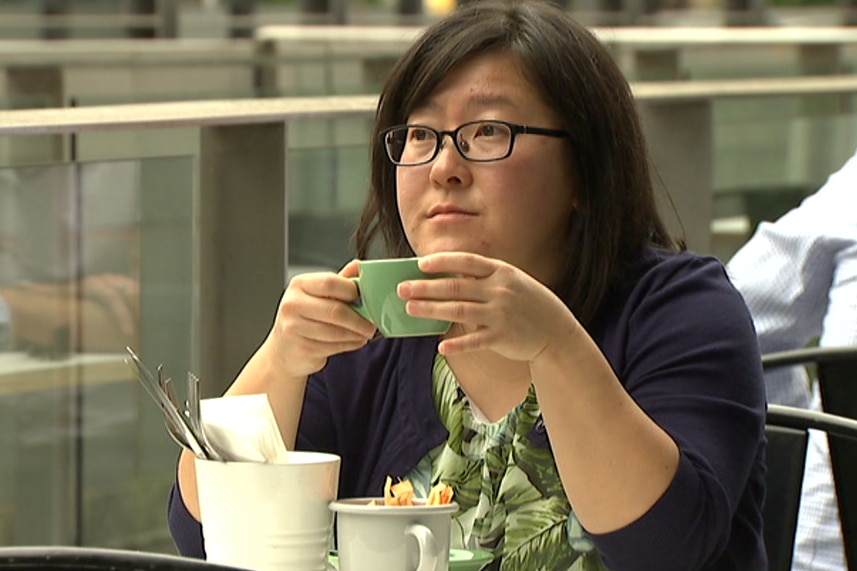 Yoke Yen Lee drinks a coffee at a cafe.