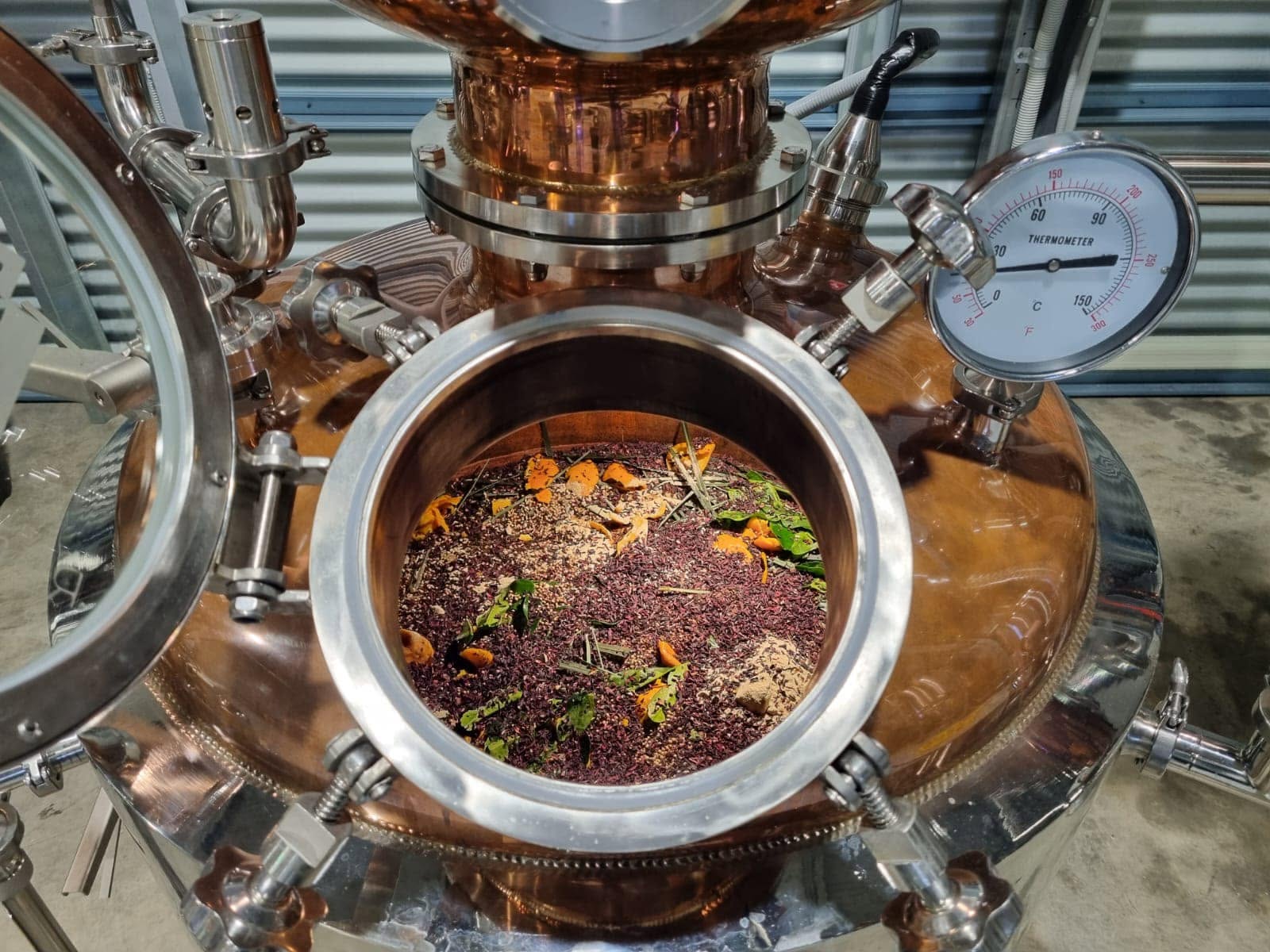 Herbs, plants and grains in bowl of bronze still with pipes and thermometer