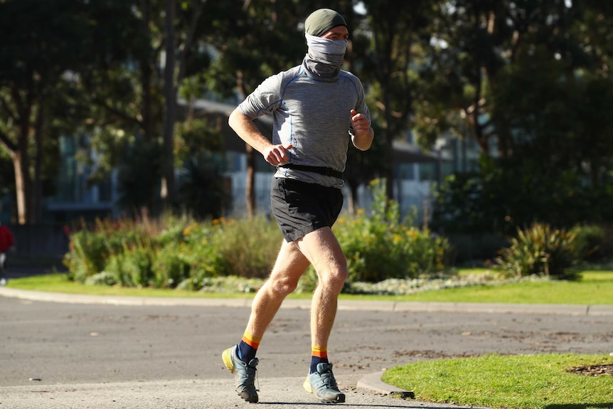 A man running in Melbourne's Carlton Gardens on July 16