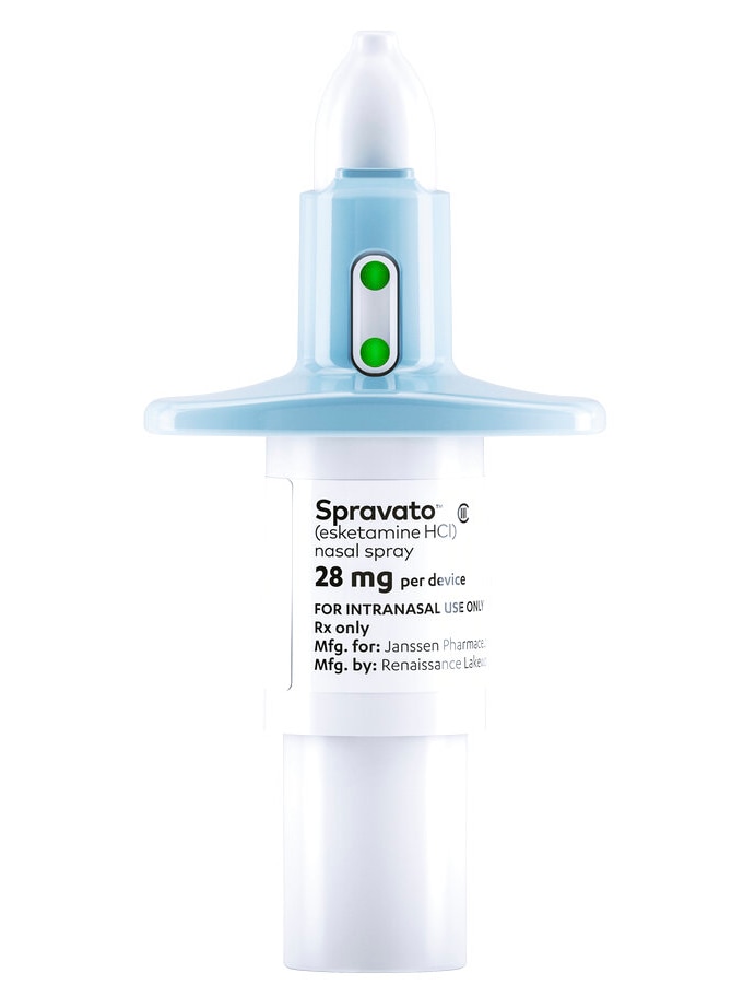 A clear and blue plastic nasal spray device, which is fitted with a medical label.