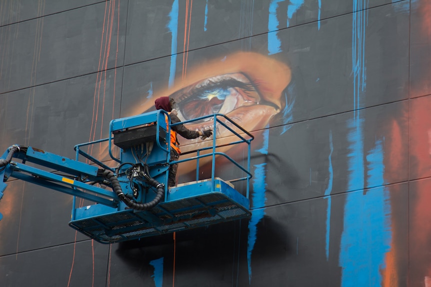 Jenny Munro mural being painted by Matt Adnate