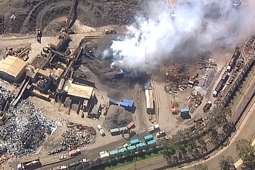 Smoke billows from a fire at a recycling plant.