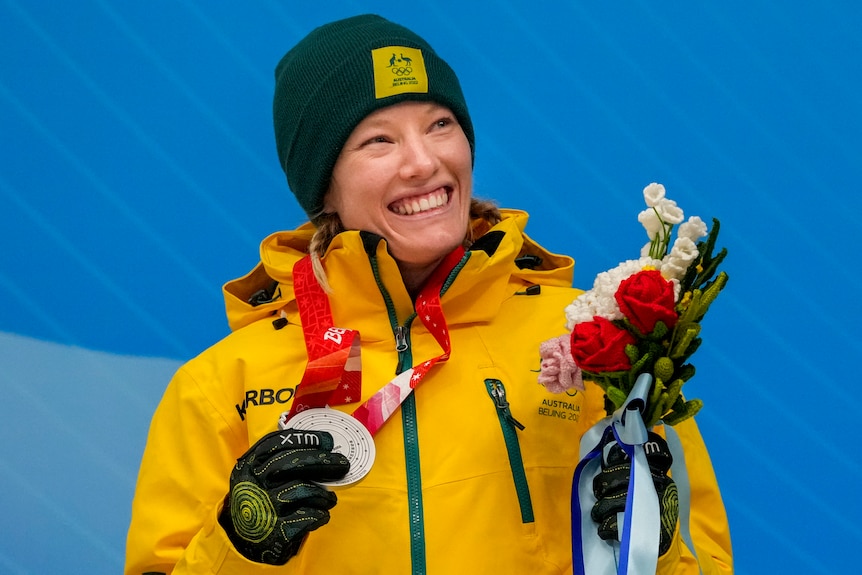 Jaclyn Narracott smiles holding a silver medal.