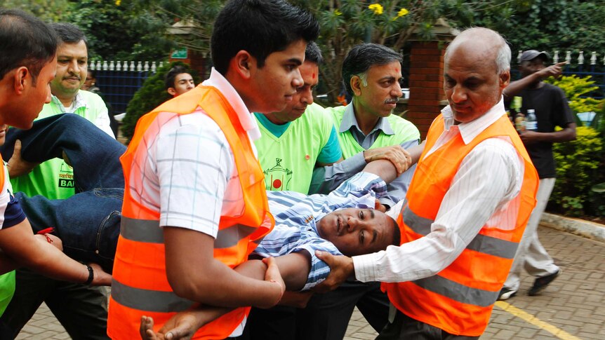 A man is carried by staff from the MP Shah hospital following the attack.