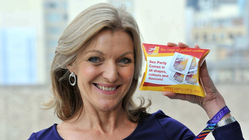 Australian Sex Party leader Fiona Patten shows off a promotional condom packet.