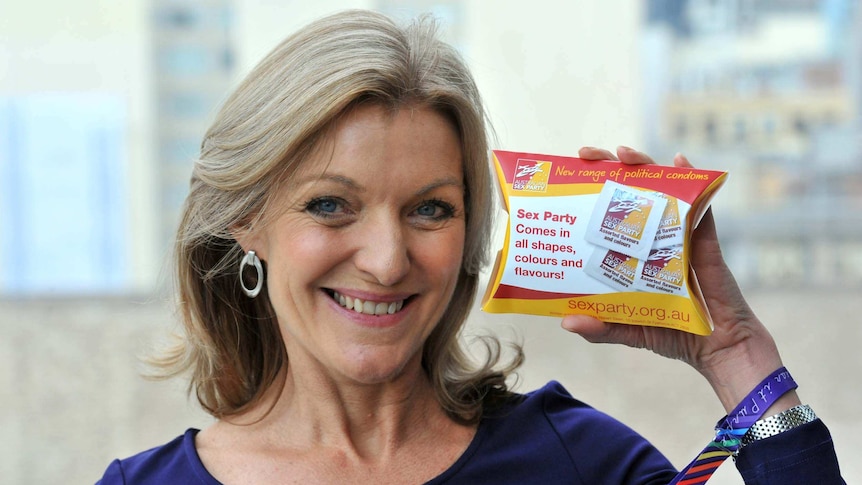 Australian Sex Party leader Fiona Patten shows off a promotional condom packet