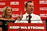 Mark McGowan makes a number one sign during victory speech while standing next to his wife.