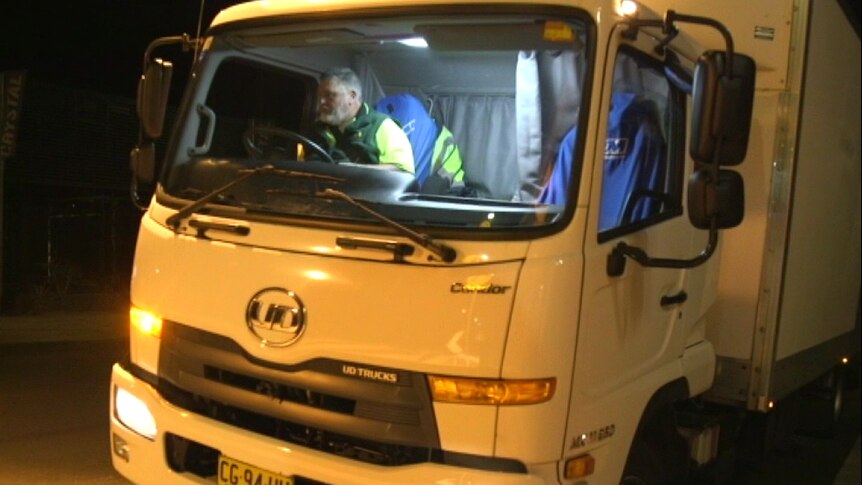 Night shot of Graeme Wong driving a bread truck