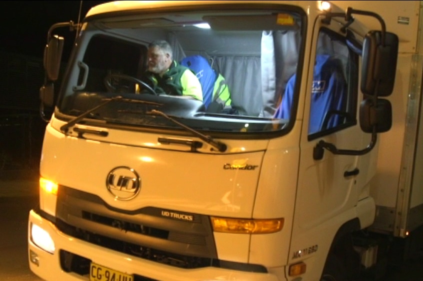Night shot of Graeme Wong driving a bread truck
