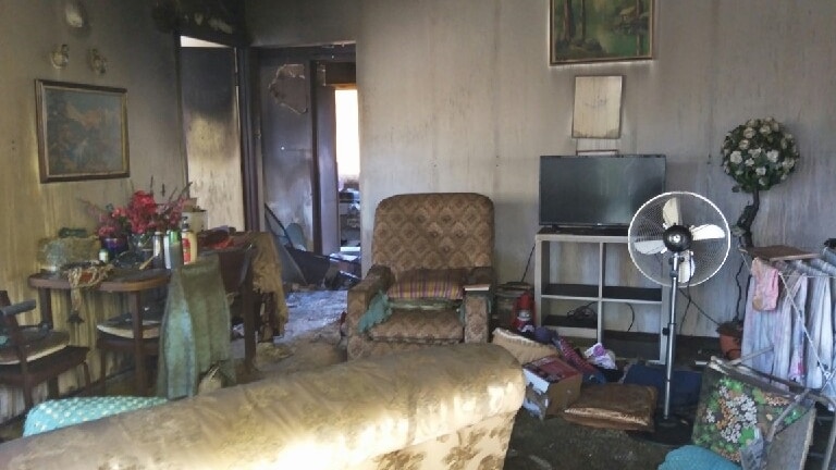 Lounge room of 89-year-old woman's fire-damaged unit at Redcliffe.
