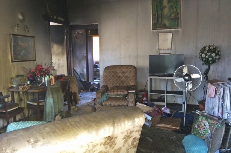 Lounge room of 89-year-old woman's fire-damaged unit at Redcliffe.