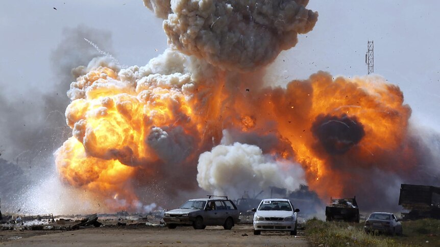 Libyan vehicles explode after coalition air strike (Reuters: Goran Tomasevic)