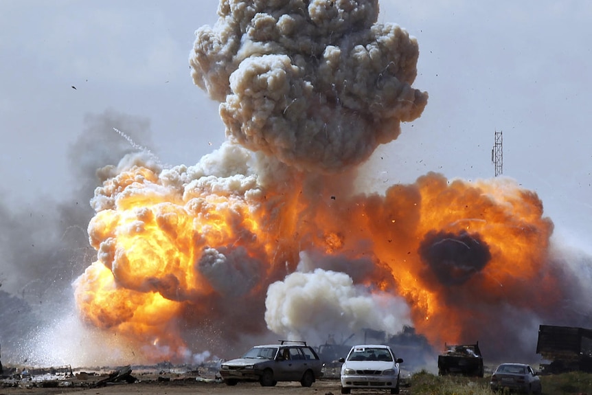 Libyan vehicles explode after coalition air strike (Reuters: Goran Tomasevic)