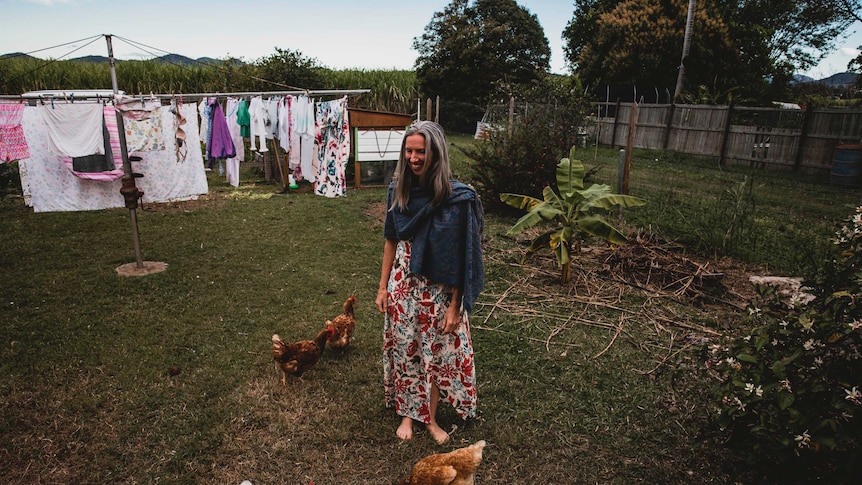 Ursula Wharton feeds the chickens in her backyard.