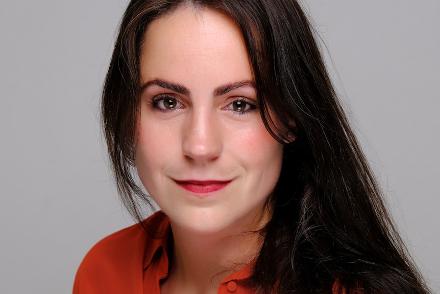 a headshot of Dr Sophie Loy-Wilson in red shirt