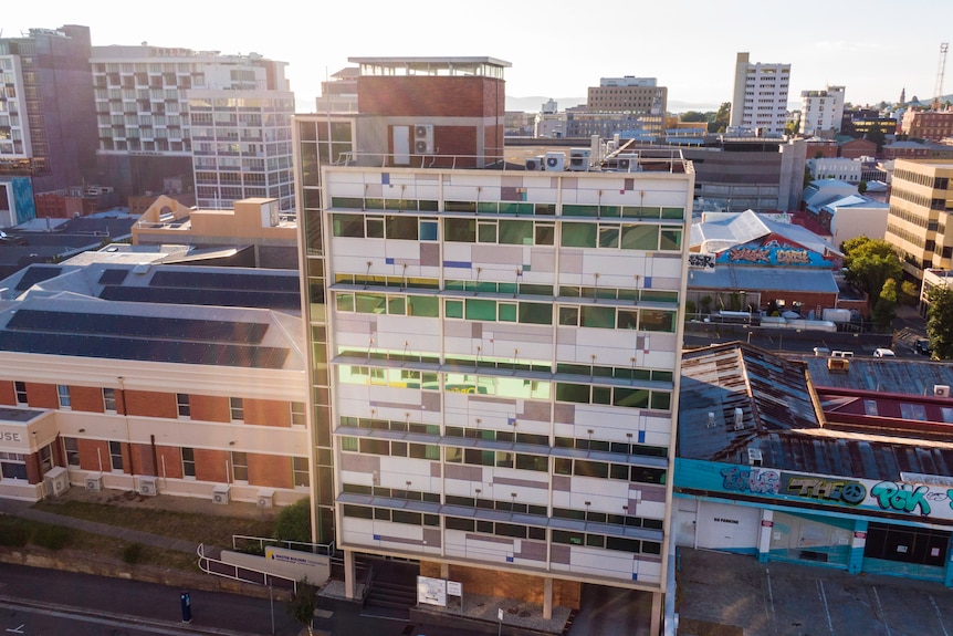 Aerial external view of Construction House, Hobart where a 20-metre rubber plant is growing in the stairwell