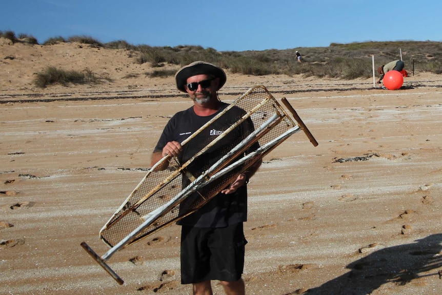 Man carrying an ironing board