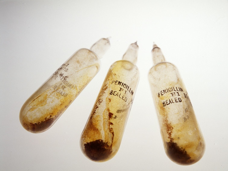 A close up of three glass vials with penicillin stamped on it.